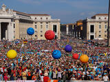 40.000 Ministrantinnen und Ministranten auf dem Petersplatz. Es werden bunte Bälle in die Masse geworfen.